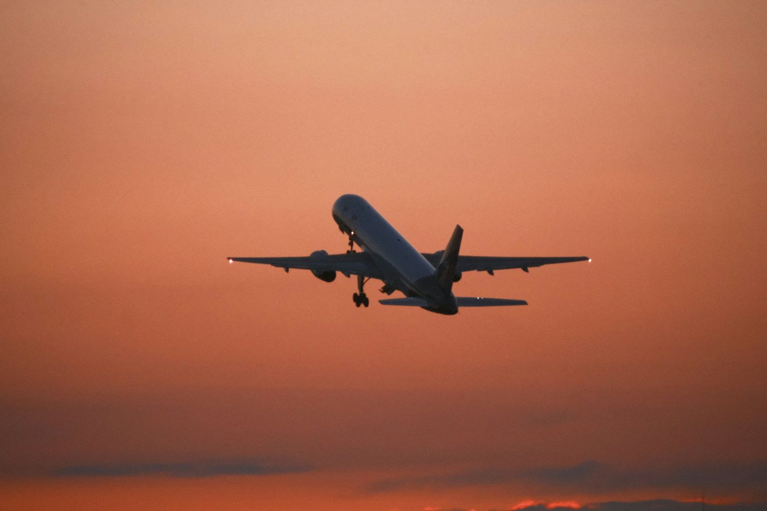 Airliner climbing at dusk