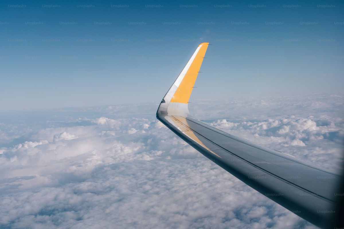 Wing over cloud